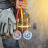 Heating and Cooling Terms Explained Air Conditioning Technician with maintenance tools.